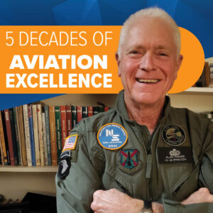 "5 Decades of Aviation Excellence" text overlayed over an image of a man with short white hair wearing an aviation uniform with numerous patches. The black patch on his left chest says in white embroidered letters "ALLEN THAMES HQ US STRATCOM".
